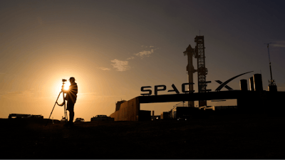 A photographer prepares to makes photos of SpaceX's mega rocket Starship as it is prepared for a test flight from Starbase in Boca Chica, Texas, Wednesday, March 13, 2024.