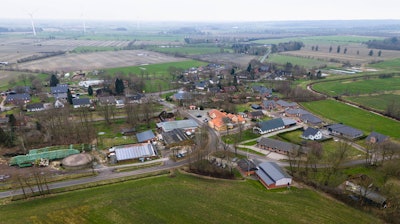 The village Sprakebuell, Germany, is shown in an aerial photo taken Thursday, March 14, 2024. Sprakebuell is something of a model village for the energy transition - with an above-average number of electric cars, a community wind farm and renewable heat from biogas. All houses in the village center have been connected to the local heating network and all old oil heating systems have been removed.