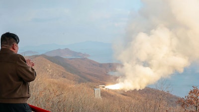In this photo provided by the North Korean government, North Korean leader Kim Jong Un, left, watches what it says a test of a solid-fuel engine for its new-type intermediate-range hypersonic missile at the Sohae Satellite Launching Ground in North Korea Tuesday, March 19, 2024. The content of this image is as provided and cannot be independently verified.