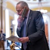 Senate Majority Leader Chuck Schumer, D-N.Y., talks on his phone on the way to a closed-door Democratic strategy session, at the Capitol in Washington, Wednesday, March 20, 2024.