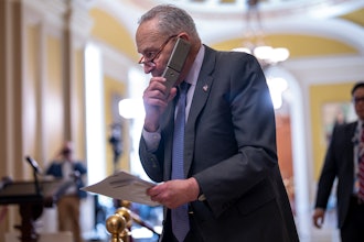 Senate Majority Leader Chuck Schumer, D-N.Y., talks on his phone on the way to a closed-door Democratic strategy session, at the Capitol in Washington, Wednesday, March 20, 2024.