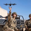 In this photo from the Defense Visual Information Distribution Service, British soldiers launch a drone during Project Convergence exercises at Fort Irwin, Calif., on Nov. 4, 2022.