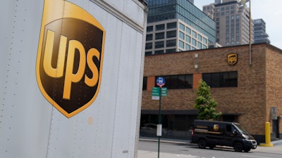 A delivery vehicle passes by a UPS depot in New York, June 29, 2023.
