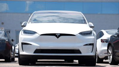 An unsold 2023 Model X sports-utility vehicle sits outside a Tesla dealership Sunday, June 18, 2023, in Englewood, Colo.