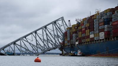 The Dali, a massive container ship from Singapore, still sits amid the wreckage and collapse of the Francis Scott Key Bridge in the Baltimore port, Monday, April 1, 2024.