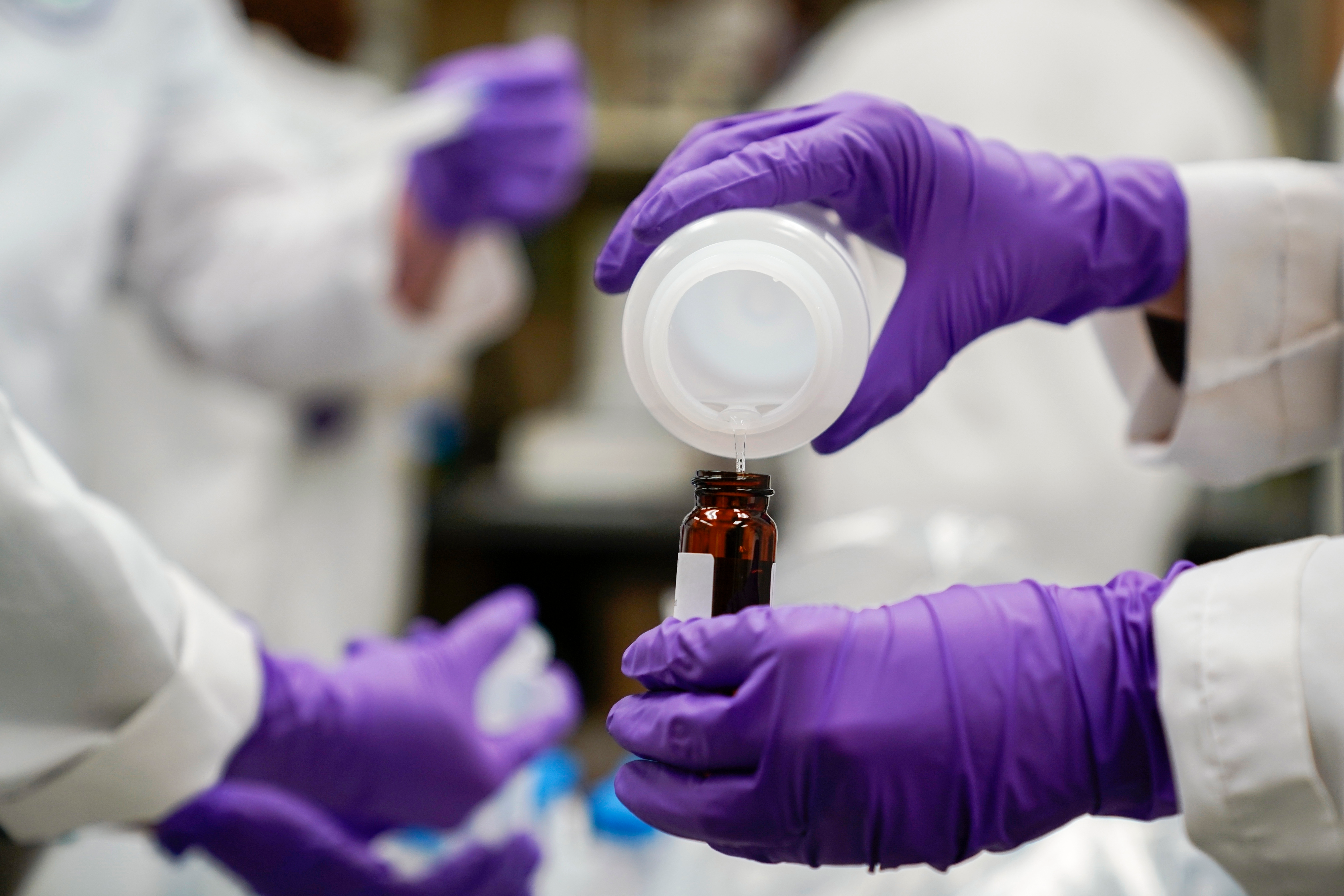 Water researcher Eva Stebel pours a sample at the EPA Center for Environmental Solutions and Emergency Response, Cincinnati, Feb. 16, 2023.