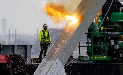 Workers are seen in the beginning stages of dismantling the steel from the frame of the collapsed Francis Scott Key Bridge, using an exothermic cutting torch, April 4, 2024, in Baltimore.