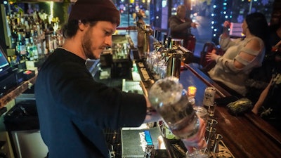 Rob Waltar, managing partner of the Fulton Grand bar in New York, make drinks for customers, Feb. 28, 2024.
