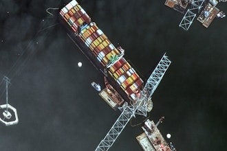 Satellite image showing the bow of the container ship Dali underneath sections of the fallen Francis Scott Key Bridge, Baltimore, April 8, 2024.