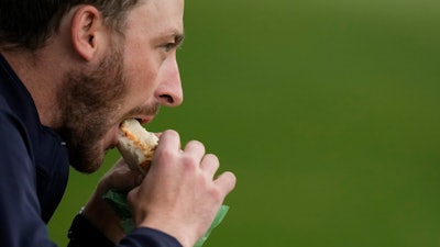 A patron eats a pimento cheese sandwich at Augusta National Golf Club, Augusta, Ga., April 9, 2024.