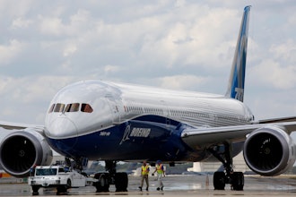 Boeing employees walk the new Boeing 787-10 Dreamliner down towards the delivery ramp area at the company's facility after conducting its first test flight at Charleston International Airport, Friday, March 31, 2017, in North Charleston, S.C.