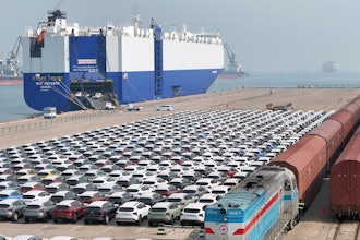 A freight train carrying cars to be exported arrives at a dock for ro-ro shipping in Yantai in eastern China's Shandong province Sunday, March 3, 2024.