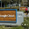 A person rides past the Google sign outside the Google offices in Sunnyvale, Calif., on Thursday, April 18, 2024.