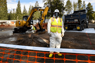 Environmental cleanup specialists work at one of the last remaining residential asbestos cleanup sites in Libby, Montana, in mid-September.