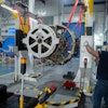 Engineers and workers stand inside Safran Aircraft Engines repair plant outside of Casablanca, Morocco, Thursday, April 18, 2024.