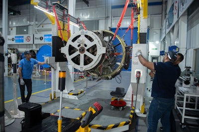 Engineers and workers stand inside Safran Aircraft Engines repair plant outside of Casablanca, Morocco, Thursday, April 18, 2024.