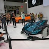 Visitors take photos of a MG concept car during an opening of China Auto Show in Beijing, China, Thursday, April 25, 2024.