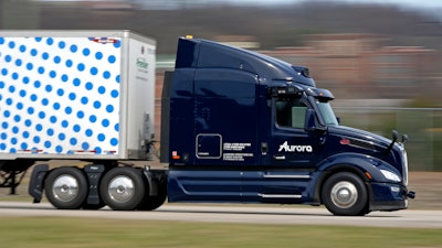 A self-driving tractor trailer maneuvers around a test track in Pittsburgh, Thursday, March 14, 2024. The truck is owned by Pittsburgh-based Aurora Innovation Inc. Late this year, Aurora plans to start hauling freight on Interstate 45 between the Dallas and Houston areas with 20 driverless trucks.
