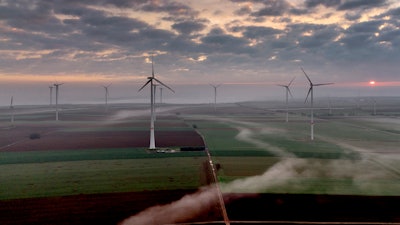Wind turbines operate at an energy plant near Stetten, north of Kaiserslautern, Germany, as the sun rises on, March 19, 2024. According to a new report published Tuesday, April 16, 2024, last year, marked the best year for new wind projects.