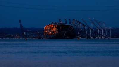 Wreckage of the Francis Scott Key Bridge rests on the container ship Dali, Sunday, March 31, 2024, in Baltimore.