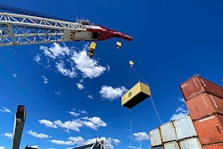 In this photo provided by the Key Bridge Response 2024 Unified Command, response crews begin removing shipping containers from the deck of the cargo ship Dali using a floating crane barge at the site of the Francis Scott Key Bridge, Sunday, April 7, 2024, in Baltimore.