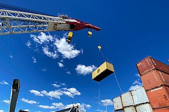 In this photo provided by the Key Bridge Response 2024 Unified Command, response crews begin removing shipping containers from the deck of the cargo ship Dali using a floating crane barge at the site of the Francis Scott Key Bridge, Sunday, April 7, 2024, in Baltimore.