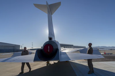 NASA and Lockheed Martin test pilots inspect the painted X-59 as it sits on the ramp at Lockheed Martin Skunk Works in Palmdale, California. The X-59 is the centerpiece of NASA’s Quesst mission, which seeks to solve one of the major barriers to supersonic flight over land, currently banned in the United States, by making sonic booms quieter.