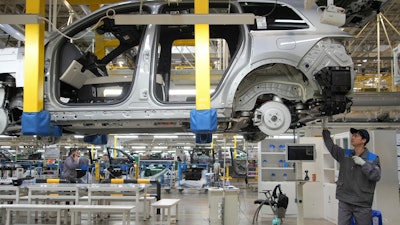 A worker assembles an SUV at a Li Auto plant, Changzhou, China, March 27, 2024.