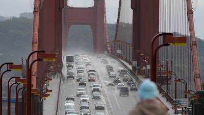 A person watches as traffic drives across the Golden Gate Bridge in Sausalito, Calif., on March 1, 2024.