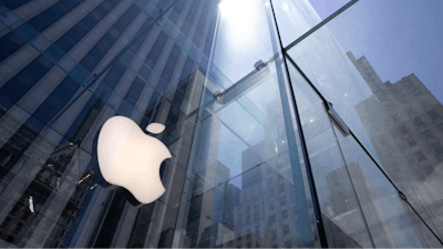 In this June 16, 2020 file photo, the sun is reflected on Apple's Fifth Avenue store in New York.