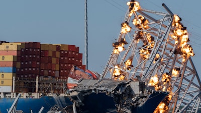 Explosive charges are detonated to bring down sections of the collapsed Francis Scott Key Bridge resting on the container ship Dali on Monday, May 13, 2024, in Baltimore.