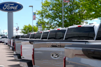 A line of unsold 2024 F150 pickup trucks sit at a Ford dealership Sunday, May 19, 2024, in Denver.