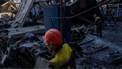 Workers walk among debris in a damaged DTEK thermal power plant after a Russian attack in Ukraine, Thursday, May 2, 2024.