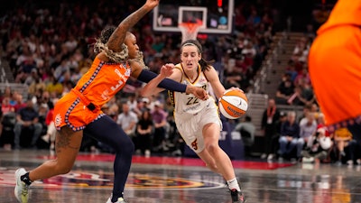 Indiana Fever guard Caitlin Clark (22) drives on Connecticut Sun guard Tiffany Mitchell (3) in the second half of a WNBA basketball game in Indianapolis, Monday, May 20, 2024.