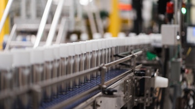 Cans going through assembly line.