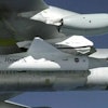 NASA’s B-52B launch aircraft cruises to a test range over the Pacific Ocean carrying the third and final X-43A vehicle, attached to a Pegasus rocket, on Nov. 16, 2004.
