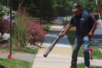 Antonio Espinoza, a supervisor with the Gras Lawn landscaping company, uses a gasoline-powered leaf blower to clean up around a housing development in Brick, N.J. on June 18, 2024.