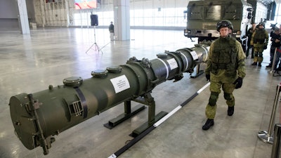A Russian military officer walks past the 9M729 land-based cruise missile on display in Kubinka outside Moscow, Russia, on Jan. 23, 2019.