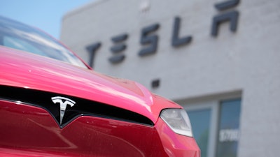 A Model X sports-utility vehicle sits outside a Tesla store in Littleton, Colo., June 18, 2023.