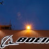 An airplane flies over a sign on Boeing's newly expanded 737 delivery center, Oct. 19, 2015, at Boeing Field in Seattle.