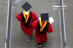 In this May 13, 2018, file photo, new graduates walk into the High Point Solutions Stadium before the start of the Rutgers University graduation ceremony in Piscataway Township, N.J.