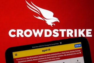 The logo for CrowdStrike and a Spirit Airlines webpage are shown on a computer screen and mobile phone screen, in New York.