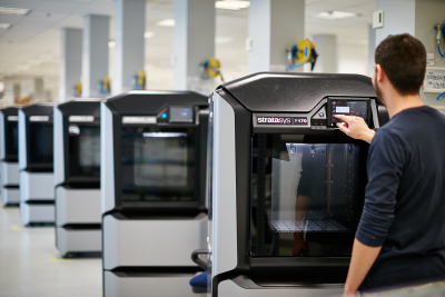 A worker receives advanced training on a Stratasys fused deposition modeling (FDM) 3D printer.