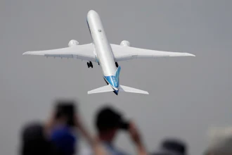 A Boeing 777X plane takes off at the Farnborough Air Show fair in Farnborough, England, on July 18, 2022.