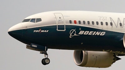 A Boeing 737 Max jet, piloted by Federal Aviation Administration (FAA) chief Steve Dickson, prepares to land at Boeing Field following a test flight on Sept. 30, 2020 in Seattle.
