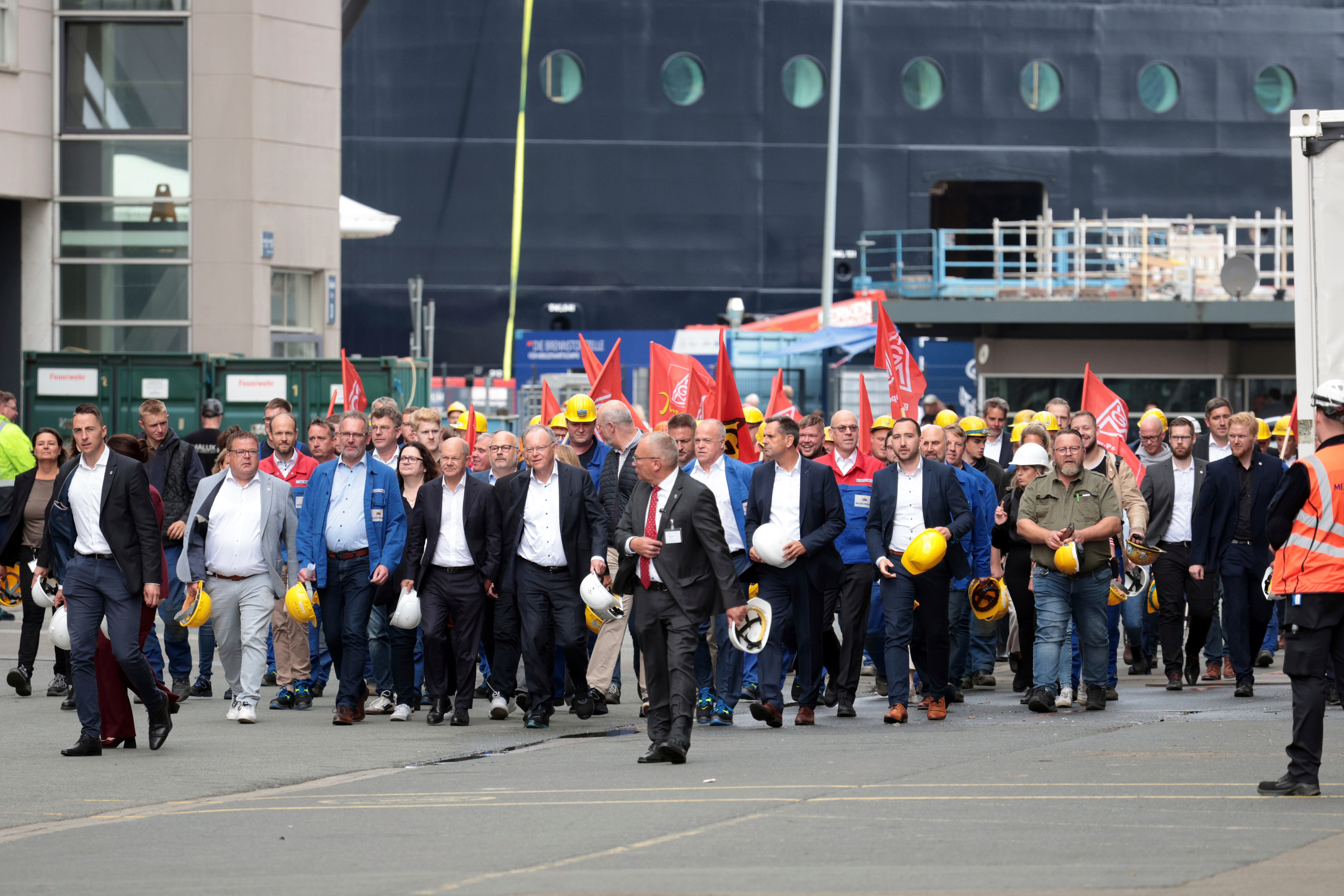 Federal Chancellor Olaf Scholz, front 4th from left, visits the Meyer Werft shipyard in Papenburg, Germany, Thursday Aug. 22, 2024.