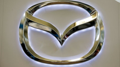 This Feb. 14, 2013, file photo, shows the Mazda logo on a sign at the 2013 Pittsburgh Auto Show, in Pittsburgh.
