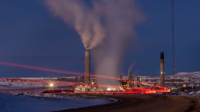 Taillights trace the path of a motor vehicle at the Naughton Power Plant, Jan. 13, 2022, in Kemmerer, Wyo., next to a site where Bill Gates and his energy company are starting construction on a next-generation nuclear plant.