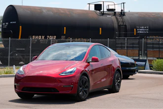 Drivers guide 2024 a Tesla Model 3 sedan and Model X utility vehicle, rear, along a test track at the Electrify Expo in The Yards on July 14, 2024, in north Denver.