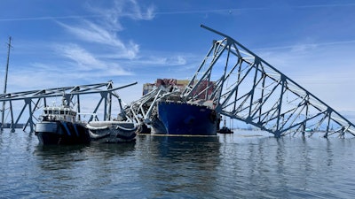 The fallen Francis Scott Key Bridge in Baltimore is pictured Sunday, March 31, 2024, where divers assisted crews with the complicated and meticulous operation of removing steel and concrete.